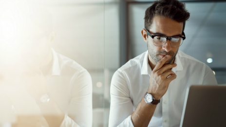 A young professional on his computer reviewing the comprehensive and diverse acceptable investments list for the Leveraged margin loan products.