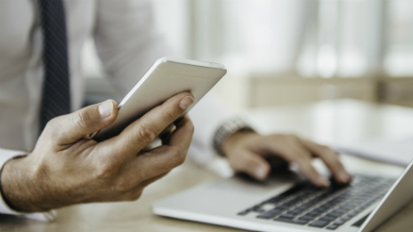 Man on a laptop accessing handy calculator tools to compare how margin loans fare when compared to other savings and investment options.